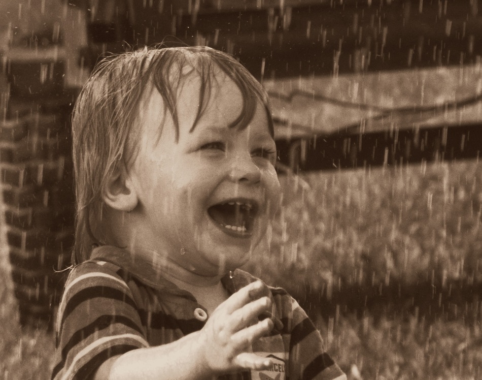 a child is laughing in the rain