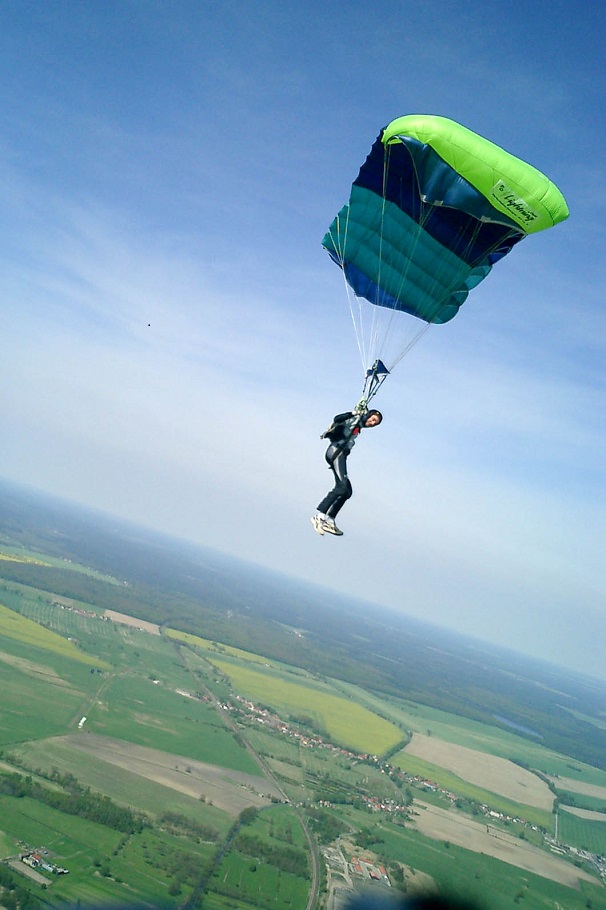a paraglider looks back at the camera while landing