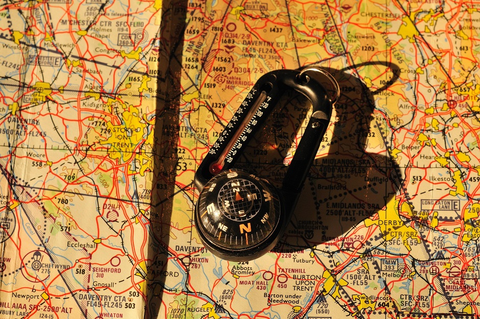 a compass rests on a map
