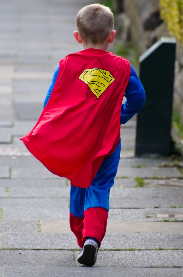 a child in a super hero costume walks away