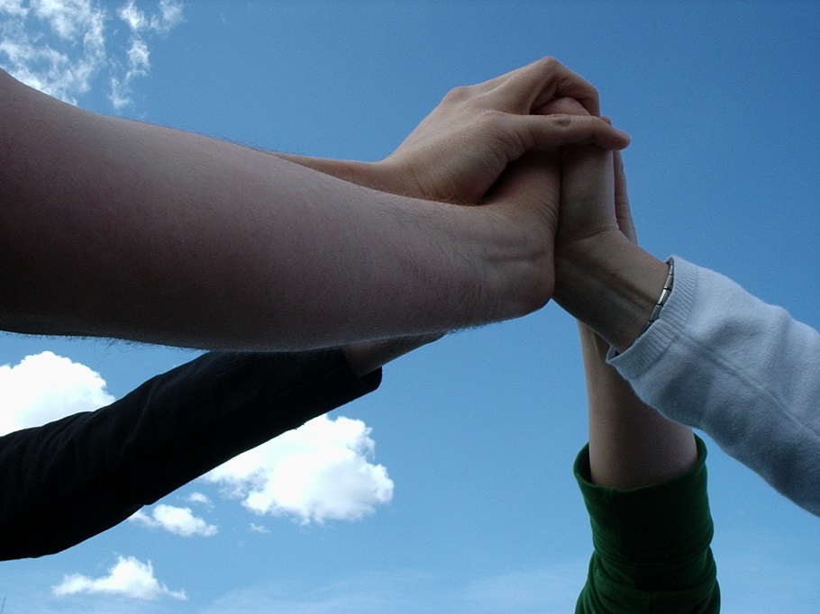 a team of people holding hands in the center